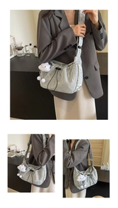 Detail of grey textured drawstring shoulder bag with a cute cloud plush pendant