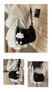 Detail of black pleated fabric crossbody bag with a cute white cloud plush pendant charm