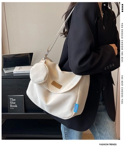Detail of off-white large capacity shoulder bag with mini coin purse and brand label