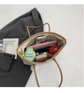 Detailed interior view of a large tote bag showing compartments for tablets and essentials