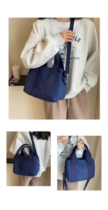 Detail view of deep blue canvas tote bag showing adjustable straps and front pocket