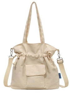 Minimalist off-white pleated drawstring tote bag with thick canvas fabric and broad strap