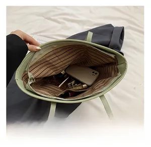 Top view of spacious straw tote interior with green lining and daily essentials