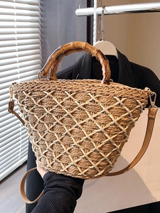 Straw hand-woven bag with bamboo handles and mesh overlay for summer beach vacations