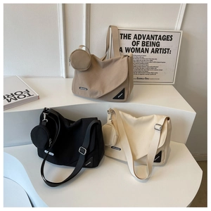 Trois sacs bandoulière en toile en kaki, noir et beige avec pochettes rondes assorties