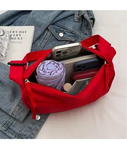 Detail of red crossbody bag interior showing organized space for phone and umbrella