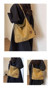 Detail view of mustard yellow canvas tote bag featuring large capacity and leather logo
