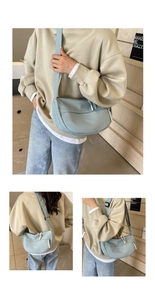 Detailed view of light blue nylon crescent crossbody bag with adjustable fabric strap