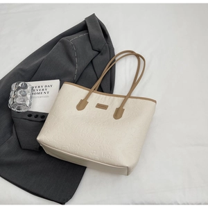 Detailed macro view of 3D embossed cute cartoon patterns on the cream white tote bag