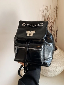 Glossy black backpack with silver butterfly lock and chain on a clean white background
