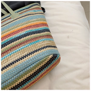 Close-up of colorful striped woven texture and bottom structure of straw tote bag