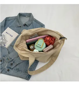 Interior view of large beige canvas tote bag showing spacious capacity for daily items