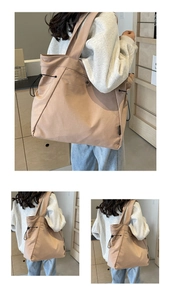 Detail of a beige nylon tote bag featuring adjustable black drawstrings and woven side label