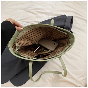 Interior view of light green tote bag showing spacious capacity and striped lining