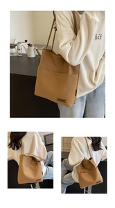 Detailed view of canvas bucket bag with metal snap button and rectangular leather patch