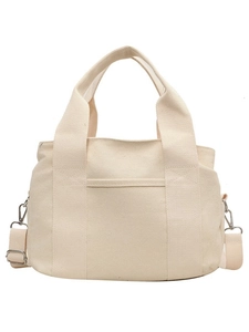 Minimalist off-white canvas tote bag with multi-layer pockets and adjustable strap