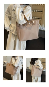 Close-up of khaki nylon tote bag showing side pocket and brown leather strap detail