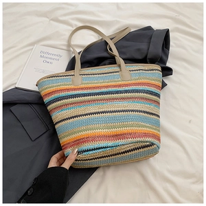 Detailed texture of a colorful striped woven straw tote bag with large capacity