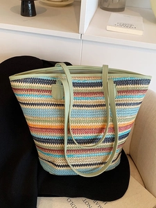 Colorful striped woven tote bag with light green leather handles and zipper closure
