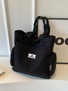 Large capacity black canvas tote bag with fashion tag and functional side pockets
