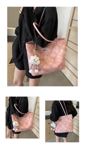 Detail view of pink quilted tote bag with cute cloud pendant and long shoulder straps