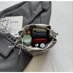 Top-down view of silver bucket bag interior showing spacious storage for daily essentials