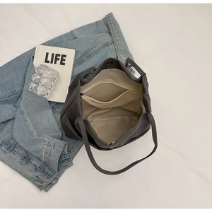 Interior detail of dark gray canvas tote bag with zipper pocket and snap closure