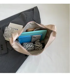 Interior view showing large capacity of the beige hobo bag with a zipper pocket