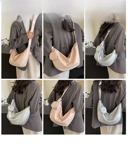 Multiple views of a stylish large crescent shoulder bag with a round coin purse attached