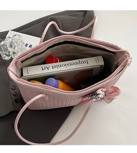Pink woven tote bag showing large interior capacity for books, tablets and essentials
