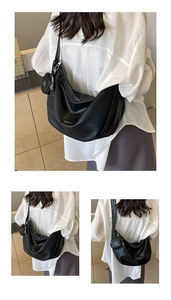 Detail of black PU crescent moon bag with detachable round coin purse and brand plaque