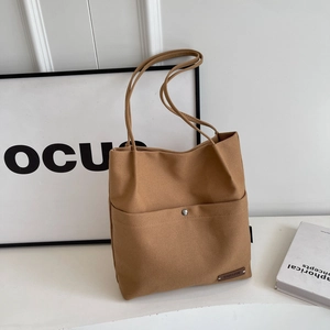 Brown canvas bucket tote bag with front pocket and double straps for women fashion