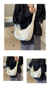 Three views of a white crescent shoulder bag with wide adjustable strap for women