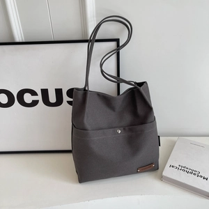 Minimalist charcoal grey canvas shoulder bag with front snap pocket and large capacity