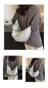 Detail of silver metallic crescent shoulder bag with detachable small round coin purse