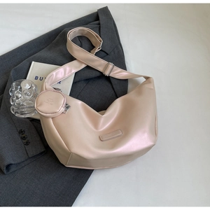 Close-up of pearl pink crescent moon shoulder bag with matching round coin pouch detail