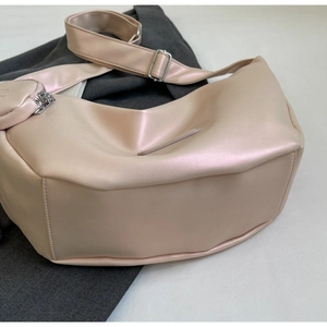 Detail of pearlescent pink hobo bag with adjustable strap and small round coin purse