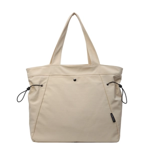 Minimalist off-white nylon tote bag with front button pocket and wide shoulder straps