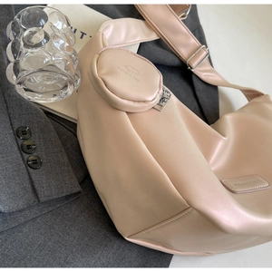 Detail view of pink leather crescent hobo bag with matching round coin pouch attachment