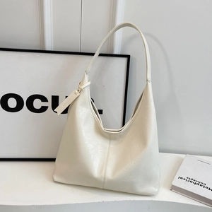 Minimalist cream white oversized hobo bag in soft textured leather with elegant shoulder strap