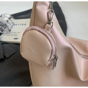 Detail of light pink moon bag with detachable coin purse and silver metallic zippers
