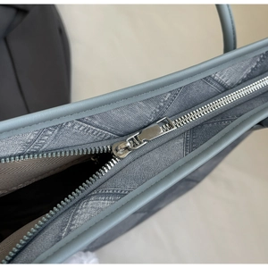 Detailed close-up of a silver zipper and blue twill fabric with herringbone lining