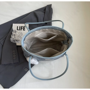 Interior view of large tote bag showing zipper pocket, dual slots and grey lining