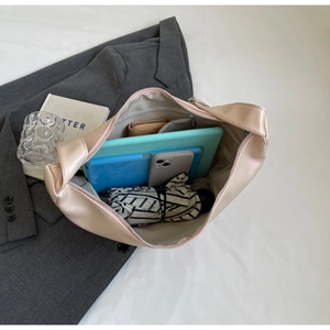 Interior view of beige minimalist hobo bag showing large storage capacity for essentials