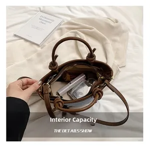 Detail view of denim bucket bag interior showing capacity for cosmetics and phone