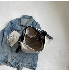 Top view of large canvas tote bag interior with inner pocket on denim jacket