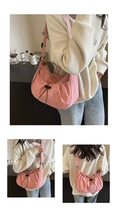 Détail du sac à bandoulière plissé rose avec fermeture à cordon de serrage noir réglable