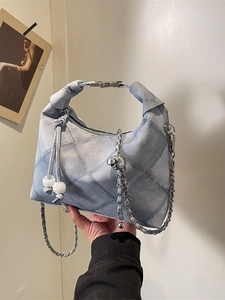 Light blue denim dumpling bag with diamond stitching and silver chain shoulder strap