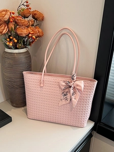 Pink woven tote bag with floral silk scarf detail for elegant summer daily commute