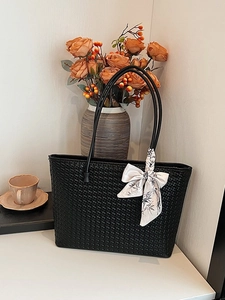Minimalist black woven tote bag with silk scarf accessory for women's daily commute
